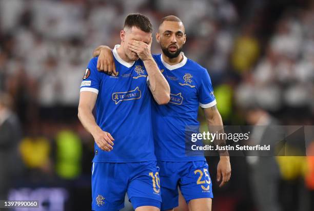 Aaron Ramsey of Rangers looks dejected as they are consoled by Kemar Roofe following defeat in the UEFA Europa League final match between Eintracht...