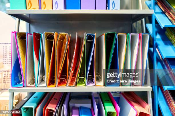 office folders for sale on a bookstore shelf. shop and school or office supplies concept. - utiles escolares fotografías e imágenes de stock