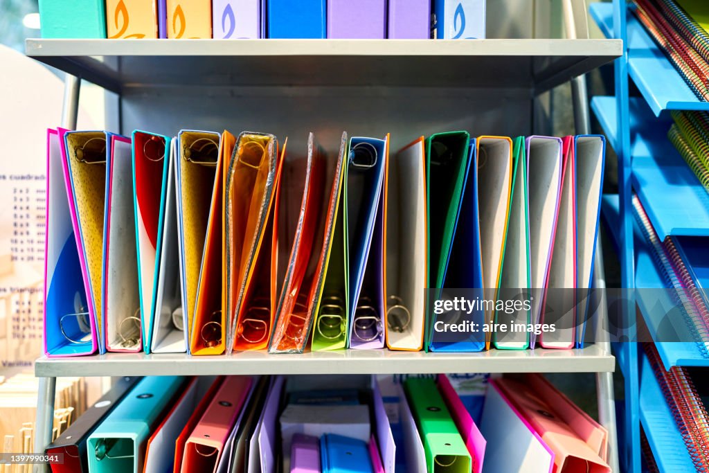 Office folders for sale on a bookstore shelf. Shop and school or office supplies concept.