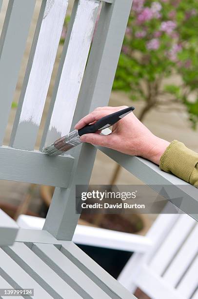 painting topcoat on garden seating - holz streichen stock-fotos und bilder