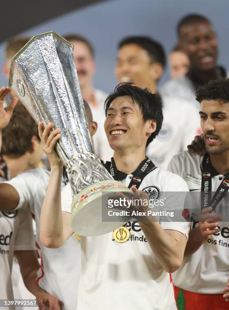 Daichi Kamada of Eintracht Frankfurt lifts the UEFA Europa League Trophy following their team's victory during the UEFA Europa League final match...