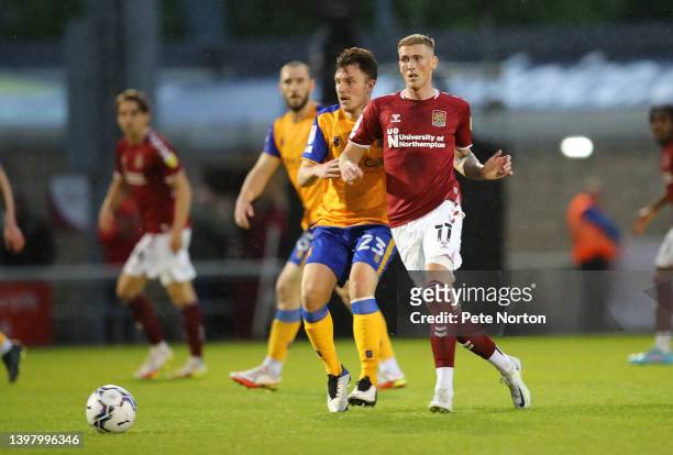 Mitch Pinnock of Northampton Town plays the ball away from Kieran Wallace of Mansfield Town during the Sky Bet League Two Play-off Semi Final 2nd Leg...