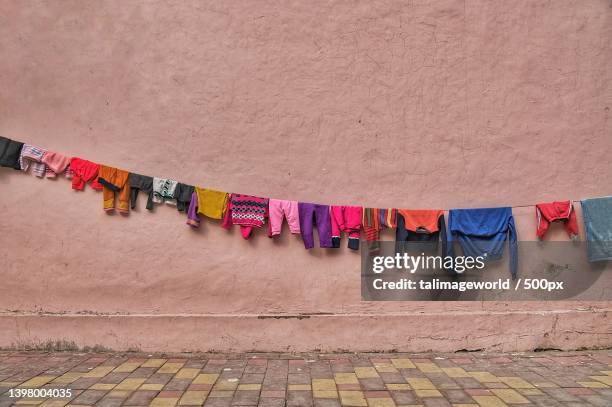 close-up of multi colored clothes hanging on wall,new delhi,delhi,india - new delhi stock photos et images de collection