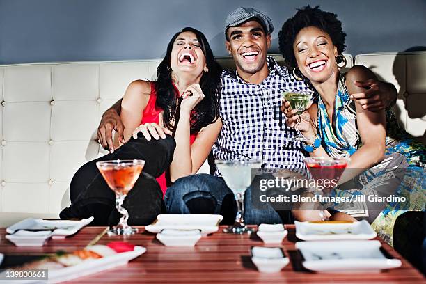 friends drinking cocktails in nightclub - los angeles no kid hungry dinner stock pictures, royalty-free photos & images