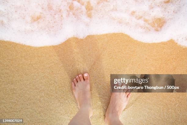 close up of a mans bare feet stand - bare footprints stock-fotos und bilder