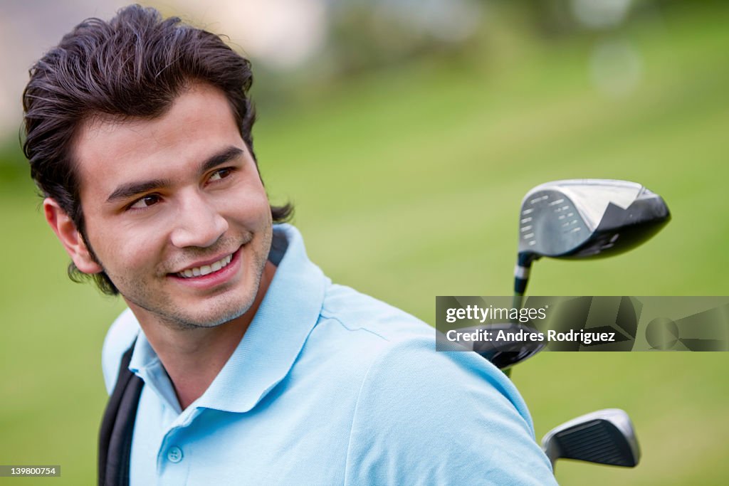 Hispanic man playing golf