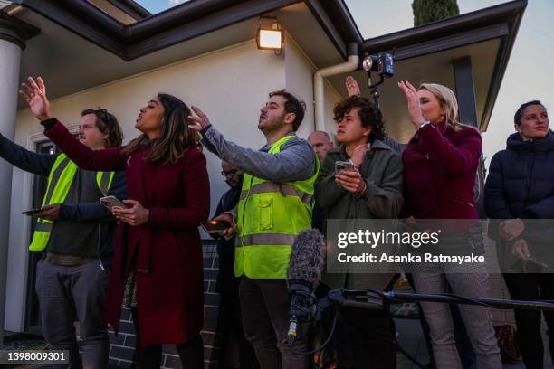 Journalists ask question towards Australian Prime Minister Scott Morrison on May 19, 2022 at Island Block & Paving in Launceston in Tasmania,...