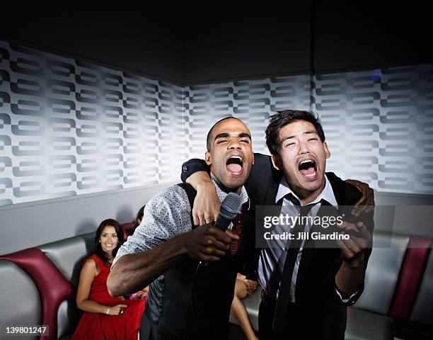 friends singing karaoke in nightclub - drunk asian women stock pictures, royalty-free photos & images