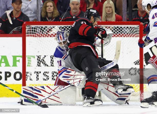 Nino Niederreiter of the Carolina Hurricanes bumps into Igor Shesterkin of the New York Rangers during the third period in Game One of the Second...