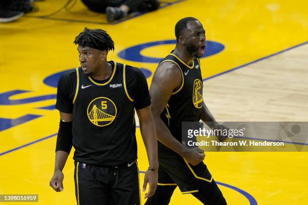 Draymond Green of the Golden State Warriors celebrates a basket with Kevon Looney against the Dallas Mavericks during the first quarter in Game One...