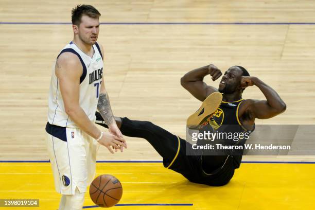 Draymond Green of the Golden State Warriors reacts against Luka Doncic of the Dallas Mavericks during the second quarter in Game One of the 2022 NBA...