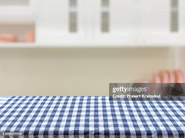blue and white checkered tablecloth on wood table in kitchen. concept for montage your text or product - empty kitchen fotografías e imágenes de stock