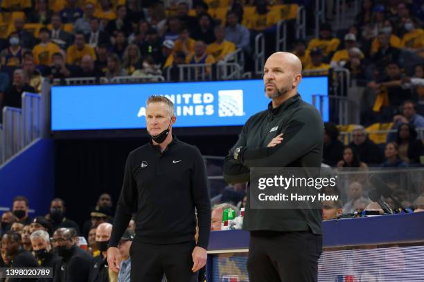 Head Coach Steve Kerr of the Golden State Warriors and head coach Jason Kidd of the Dallas Mavericks look on during the first quarter in Game One of...