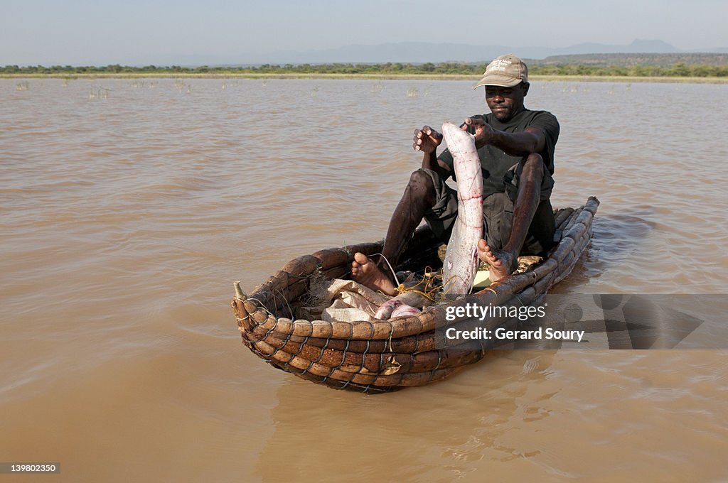 Fisherman on boat, Lake Baringo, Kenya, Africa