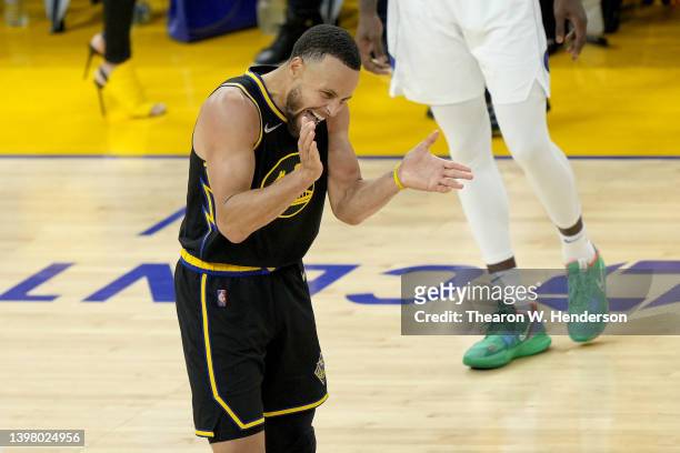 Stephen Curry of the Golden State Warriors celebrates after shooting a three point basket against the Dallas Mavericks during the third quarter in...