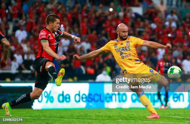 Hugo Nervo of Atlas fights for the ball with Carlos Gonzalez of Tigres during the semifinal first leg match between Atlas and Tigres UANL as part of...