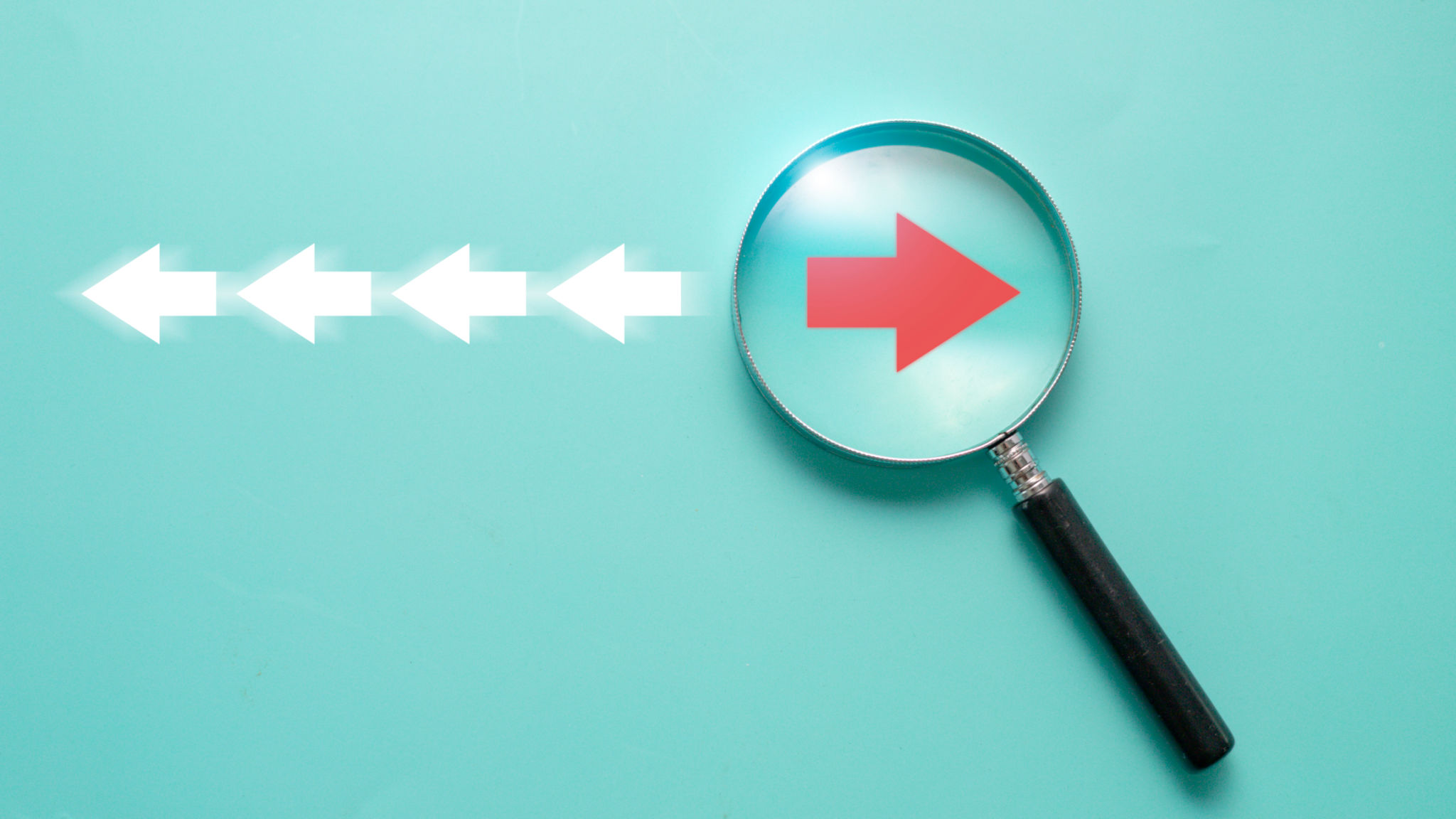 Red arrow inside of magnifier glass and different direction from white arrow for focus business disruption and technology transformation concept. Red arrow inside of magnifier glass and different direction from white arrow for focus business disruption and technology transformation concept.