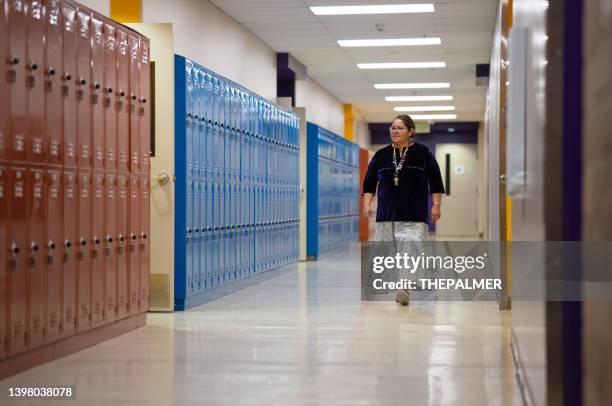 teacher walking and checking the school corridors - principal stock pictures, royalty-free photos & images
