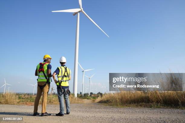 wind turbine technicians testing electrical components system at site work - site hoarding stock pictures, royalty-free photos & images