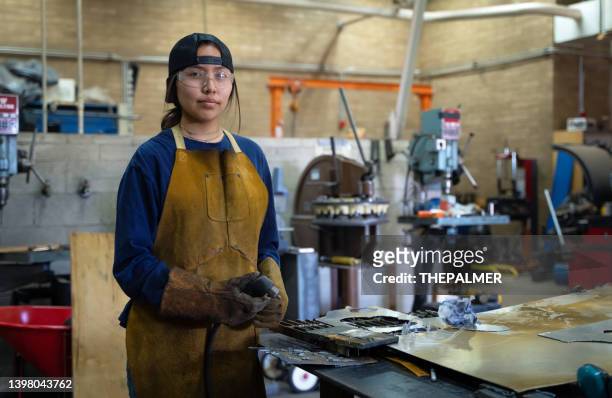 female teenager portrait at her school workshop - young worker stock pictures, royalty-free photos & images