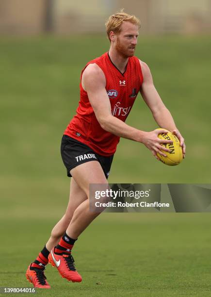 Aaron Francis of the Bombers controls the ball during an Essendon Bombers AFL training session at The Hangar on May 19, 2022 in Melbourne, Australia.