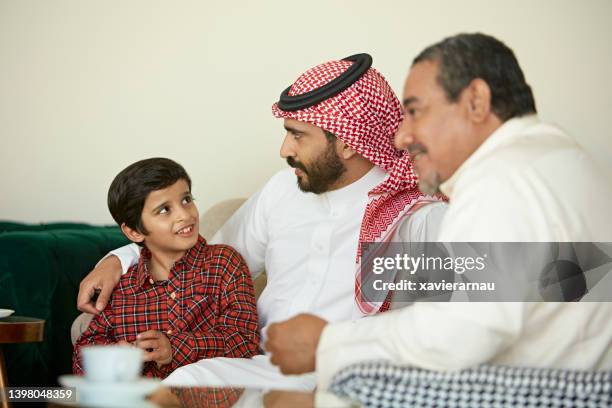 young saudi boy at home with father and grandfather - saudi grandfather stock pictures, royalty-free photos & images