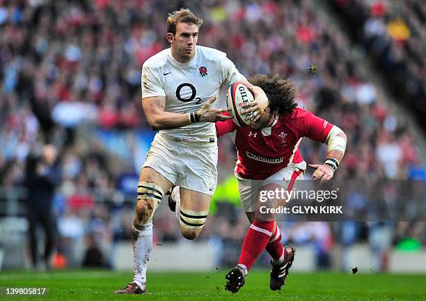England's flanker Tom Croft runs past Wales' prop Adam Jones during the 6 Nations International rugby union match between England and Wales at...