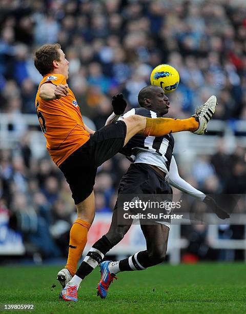 Newcastle forward Demba Ba is challenged by Richard Stearman of Wolves during the Barclays Premier League match between Newcastle United and...