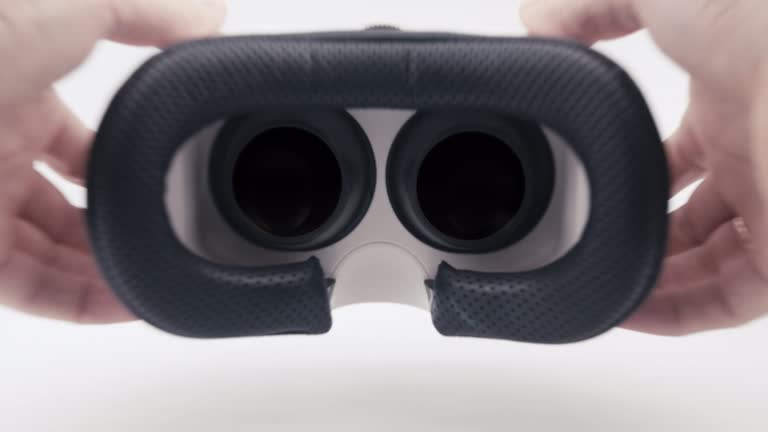 First Vr Mask Virtual reality mask. Close up. POV shot of putting on a VR helmet with ...