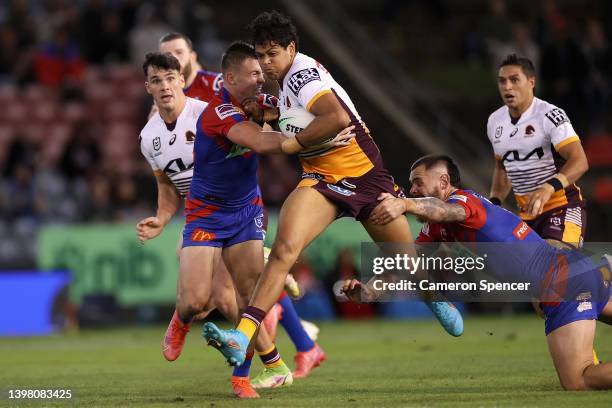 Selwyn Cobbo of the Broncos is tackled during the round 11 NRL match between the Newcastle Knights and the Brisbane Broncos at McDonald Jones...