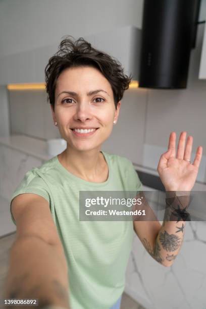 smiling woman taking selfie at home - selfie woman bildbanksfoton och bilder