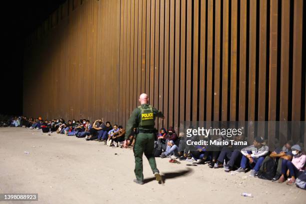 Border Patrol agent monitors immigrants after they crossed the border with Mexico on May 18, 2022 in Yuma, Arizona. Title 42, the controversial...