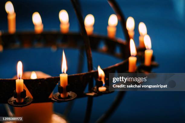 close-up of candle in the church - christmas candles stock-fotos und bilder