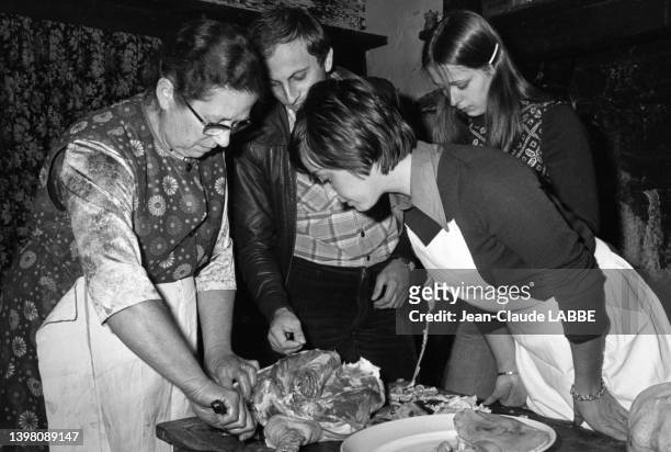 Des touristes apprennent à réaliser du foie gras et du confit de canard dans le Tarn, en décembre 1977.