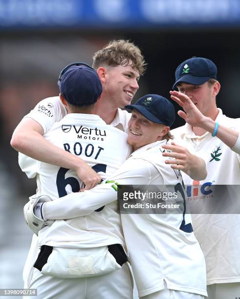 Yorkshire bowler Matthew Revis congratulates catcher Joe Root after the pair combined to dismiss Warwickshire batsman Sam Hain during the LV=...