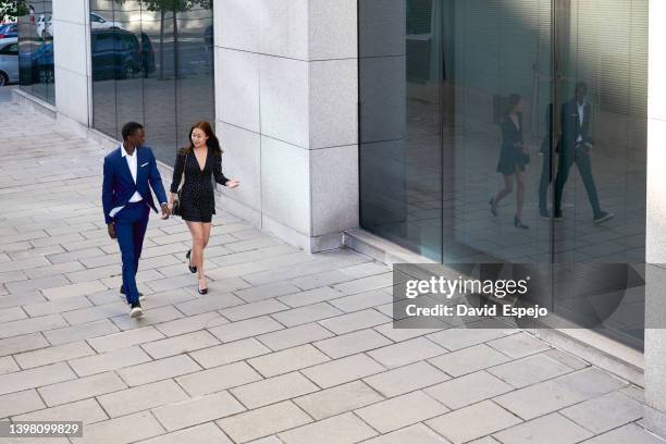 aerial view of two coworkers discussing on their way to a meeting - people business meeting birdseye stock pictures, royalty-free photos & images