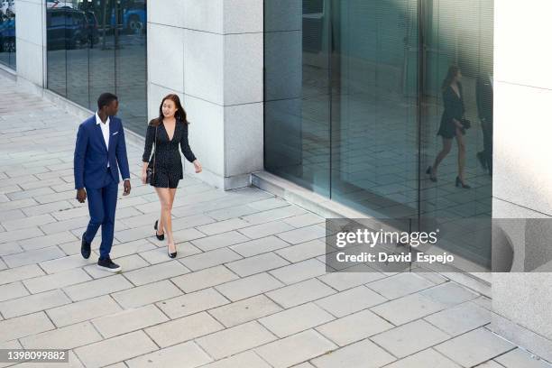 aerial view of two coworkers discussing on their way to a meeting - arial view business meeting stock pictures, royalty-free photos & images