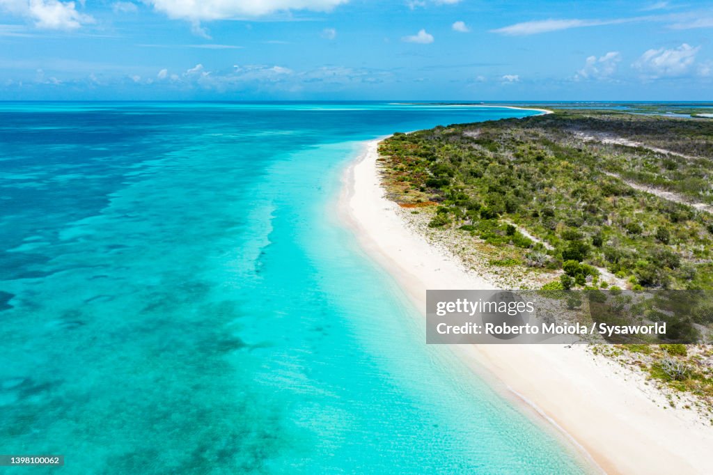 White sand beach washed by Caribbean sea, overhead view