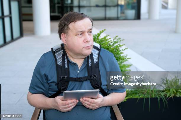 adult autistic male sitting along with his digital tablet - autism adult stock pictures, royalty-free photos & images