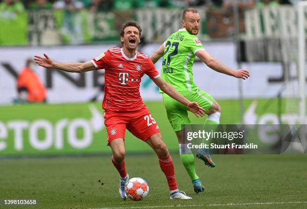 Maximilian Arnold of Wolfsburg challenges Thomas Mueller of Bayern Munich in action during the Bundesliga match between VfL Wolfsburg and FC Bayern...