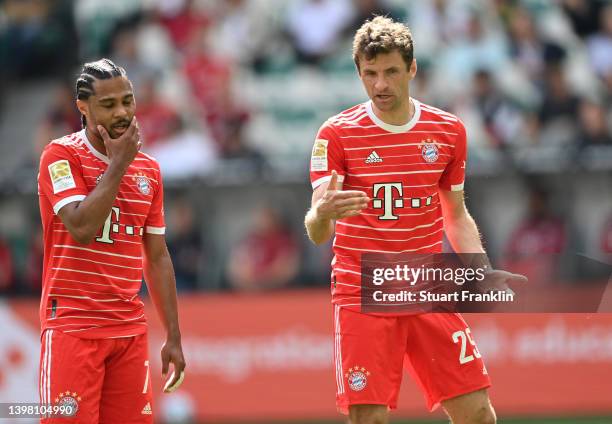 Serge Gnabryand Thomas Mueller of Bayern Munich discuss during the Bundesliga match between VfL Wolfsburg and FC Bayern München at Volkswagen Arena...