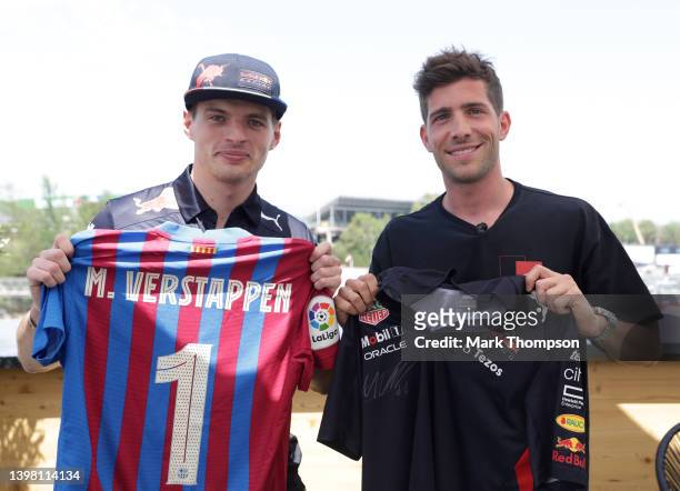 Max Verstappen of the Netherlands and Oracle Red Bull Racing is presented with a FC Barcelona shirt by Sergi Roberto during previews ahead of the F1...