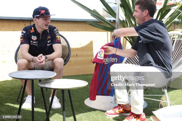 Max Verstappen of the Netherlands and Oracle Red Bull Racing is presented with a FC Barcelona shirt by Sergi Roberto during previews ahead of the F1...