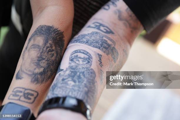 Fan of Max Verstappen of the Netherlands and Oracle Red Bull Racing shows off their tattoos during previews ahead of the F1 Grand Prix of Spain at...