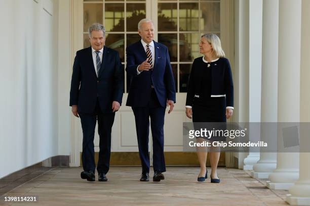 President Joe Biden walks with Finland's President Sauli Niinisto and Sweden's Prime Minister Magdalena Andersson along the Rose Garden colonnade to...