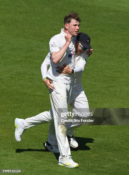 Yorkshire bowler Matthew Revis celebrates with Dom Bess after taking the wicket of Warwickshire batsman Matt Lamb during the LV= Insurance County...