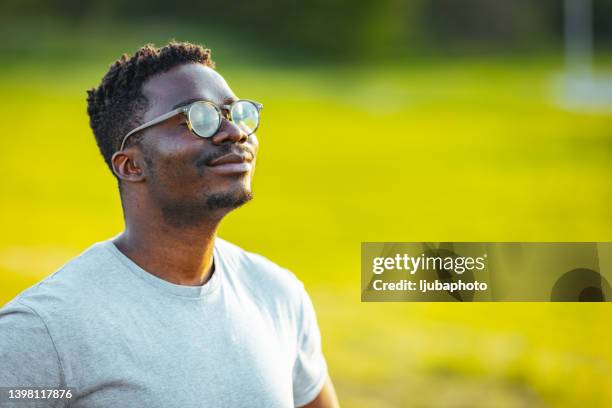 calm man meditating in sunny summer day - deep breathing stock pictures, royalty-free photos & images
