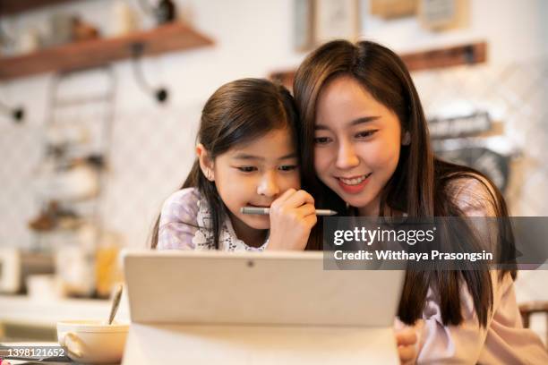 mother and daughter having fun with digital tablet - surprised woman looking at tablet stock pictures, royalty-free photos & images