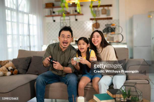 parents spend free time with daughters attend game competitions win white light inside modern indoor - asian games day 9 stock-fotos und bilder