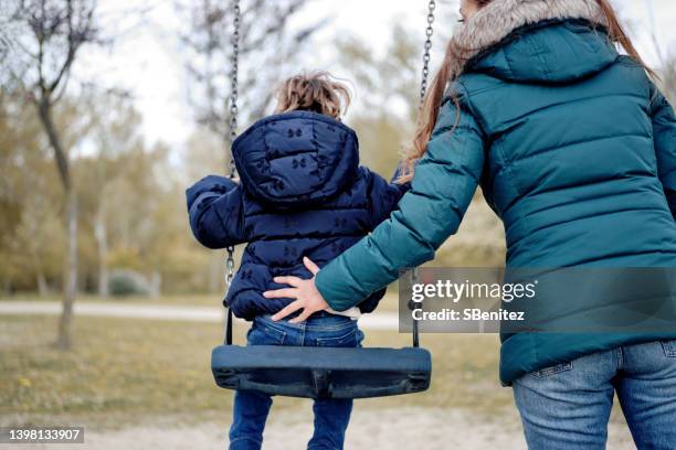 mother and daughter at the park together - child rear view stock pictures, royalty-free photos & images